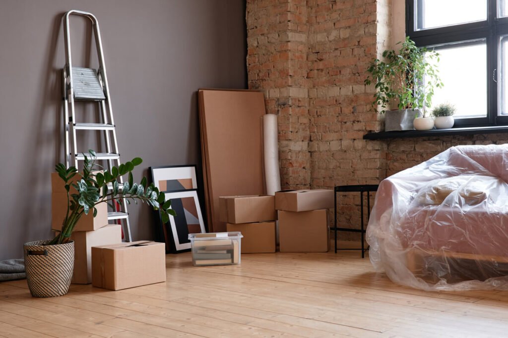 Des cartons de déménagement empilés dans un salon vide après la fin d'un contrat de garde.